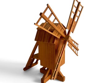 Puede incluir: Un modelo de madera de un molino de viento que presenta una estructura principal rectangular vertical con un techo inclinado, cuatro grandes aspas de estilo celosía unidas a un eje central y una base de soporte con patas anguladas.