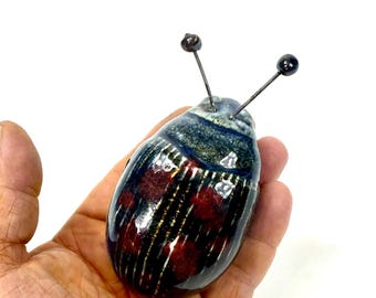 Ceramic beetle figurine, hand-painted insect art from sweden.