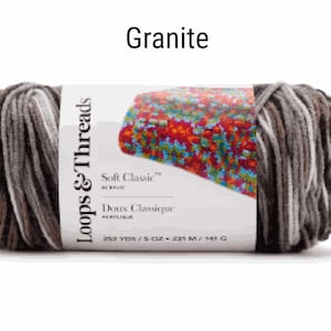 May include: A skein of Loops & Threads Soft Classic acrylic yarn in the Granite colorway. The yarn is a variegated mix of brown, gray, and white. The label reads "Loops & Threads Soft Classic Acrylic, Doux Classique ACRYLIQUE, 262 YDS/5 OZ - 239 M/141 G."