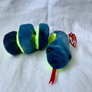 May include: A green and blue snake Beanie Baby with a red tongue and a Ty tag.