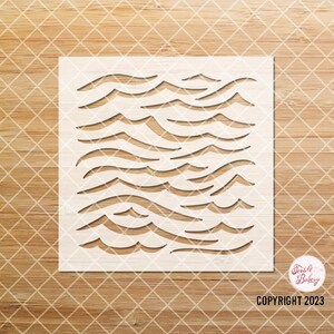 May include: White stencil with a repeating pattern of wavy lines. The stencil is designed for use with paint or other mediums to create a decorative effect.