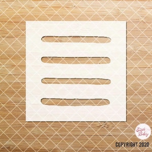 May include: White stencil with five horizontal lines, designed for use in baking and decorating cakes.