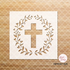 May include: A wooden stencil featuring a cross design, surrounded by a wreath of leaves and hearts. The stencil is light beige and has the text "COPYRIGHT 2025". The design is suitable for crafts and DIY projects.