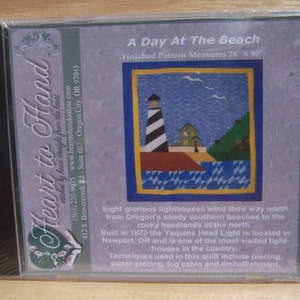May include: A Day At The Beach quilt pattern featuring a lighthouse, houses, and a blue sky. The finished pattern measures 78 inches by 90 inches. Eight glorious lighthouses wind their way north from Oregon's sandy southern beaches to the rocky headlands of the north. Built in 1873 the Yaquina Head Light is located in Newport, OR and is one of the most visited lighthouses in the country. Techniques used in this quilt include piecing, paper-piecing, log cabin and embellishment.