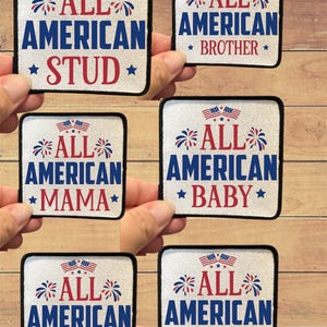 May include: A collection of square patches with patriotic designs. Each patch features the words "ALL AMERICAN" in blue, with a red word below, such as "STUD" or "MAMA". The patches include stars, fireworks, and American flags.