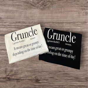 May include: Two t-shirts with the word "Gruncle" defined as "It means great or grumpy depending on the time of day!" One t-shirt is white with black text, the other is black with white text.