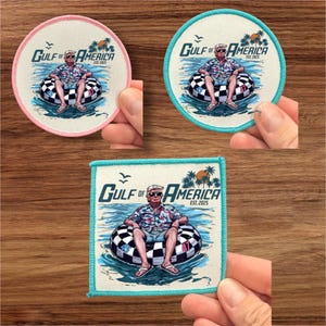 May include: Three embroidered patches with a cartoon illustration of a man in a Hawaiian shirt and sunglasses floating on a checkered inner tube. The patches are in different shapes and colors: a pink circle, a blue circle, and a square with a turquoise border. The text on the patches reads "GULF OF AMERICA EST. 2025".