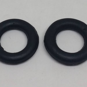 May include: Two black rubber o-rings. The o-rings are round and have a smooth surface.