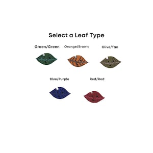 May include: Five different colored leaf-shaped buttons with a cartoon face on each. The colors are green, orange, olive, blue, and red.