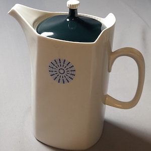 May include: White ceramic coffee pot with a dark green lid and a blue and white geometric design.