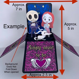 May include: A pop-up card with a purple and black background. The card is open and shows a 3D scene of Jack Skellington and Sally from the Nightmare Before Christmas. The card is decorated with roses and the text 'Simply meant to be'. The card is approximately 7 inches tall, 5 inches wide, and 2.5 inches deep.