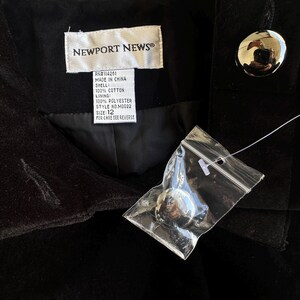 May include: Black velvet jacket with large silver buttons. The label reads "NEWPORT NEWS" and includes details about the shell, lining, and size 12. A new button is attached in a plastic bag.