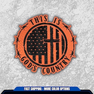 May include: An orange patch with the text "THIS IS GOD'S COUNTRY" encircling a design of the American flag and a cross. The design is surrounded by a barbed wire border.
