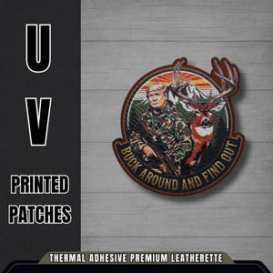 May include: A circular patch featuring a man in camouflage holding a rifle, with a deer and mountain backdrop. Text reads "BUCK AROUND AND FIND OUT." The patch is brown with a thermal adhesive premium leatherette backing.