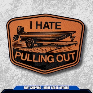 May include: Orange and black patch with the text "I HATE PULLING OUT" above an illustration of a boat on a trailer. The patch has a black border and a textured appearance.