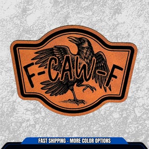 May include: A rectangular sticker with a black border and a crow illustration. The crow is black and has its wings spread. The sticker has the text "F-CAW-F" in black.