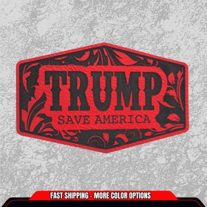 May include: A red and black patch with the word "TRUMP" in bold letters, and the words "SAVE AMERICA" below. The patch has a decorative floral design around the edges. The background is a textured gray.