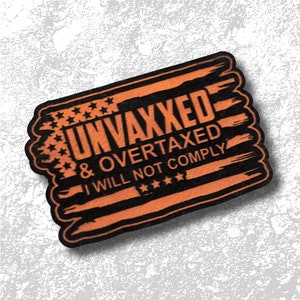 May include: A wooden rectangular sign with an orange and black design. The sign features the text "UNVAXXED & OVERTAXED I WILL NOT COMPLY" in a bold font, with stars and stripes design.