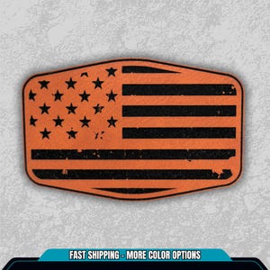 May include: An orange and black distressed American flag design. The flag features black stripes and stars on an orange background. The shape is rectangular with rounded corners. The text "FAST SHIPPING - MORE COLOR OPTIONS" is at the bottom.