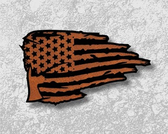 May include: A distressed American flag design with a brown and black color scheme. The flag features the traditional stars and stripes, with a weathered, torn appearance. The image is set against a textured gray background.