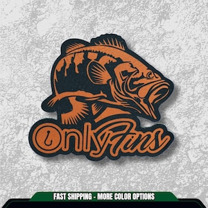 May include: A black and orange graphic of a fish with the text "Only Fins". The fish is stylized with open mouth and detailed fins. The design is on a textured background.