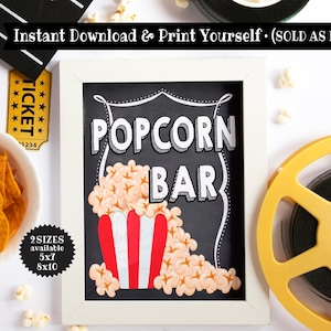 K&ouml;nnte beinhalten: Ein wei&szlig; gerahmtes Schild aus Schiefer mit dem Text "POPCORN BAR" in schwarz-wei&szlig;en Buchstaben. Das Schild ist mit einem rot-wei&szlig; gestreiften Popcorn-Eimer und Popcorn-Kernen verziert. Das Schild befindet sich auf einem wei&szlig;en Hintergrund mit einer gelben Filmrolle und einem Ticket.