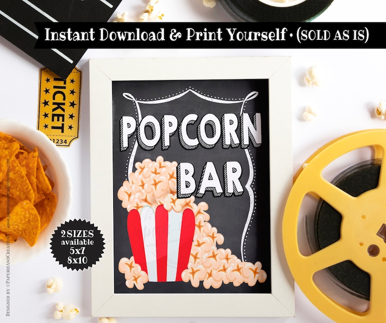 K&ouml;nnte beinhalten: Ein wei&szlig; gerahmtes Schild aus Schiefer mit dem Text "POPCORN BAR" in schwarz-wei&szlig;en Buchstaben. Das Schild ist mit einem rot-wei&szlig; gestreiften Popcorn-Eimer und Popcorn-Kernen verziert. Das Schild befindet sich auf einem wei&szlig;en Hintergrund mit einer gelben Filmrolle und einem Ticket.