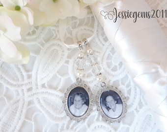 May include: Two white satin ribbon charms with silver frames and black and white photos of older adults. The charms are decorated with white pearls and clear crystals.
