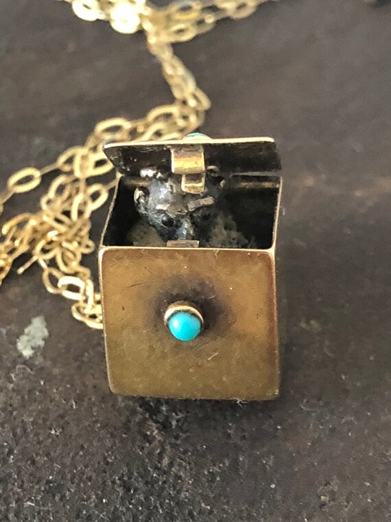Antique 'devil in the dice' pendant