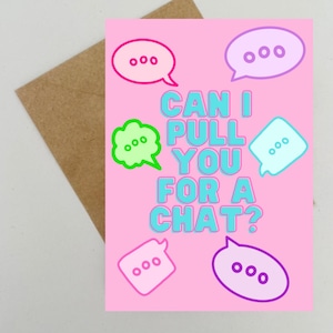 May include: A pink greeting card with the text "CAN I PULL YOU FOR A CHAT?" in blue and white. The card features speech bubbles in pink, green, and blue. A brown envelope is visible in the background.