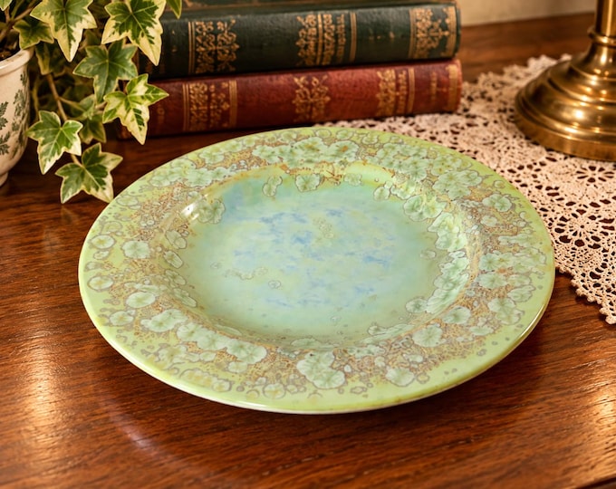 A pale green plate with a stylised floral pattern /  designed by  Max Studio