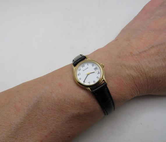 Vintage Accurist Ladies Watch: white dial, Gold Finish, black Leather Strap (y28)