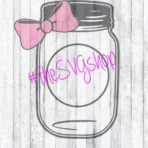 May include: A gray mason jar with a pink bow on top. The jar has a circle in the center with the text "#theSVGsShop" written in pink.