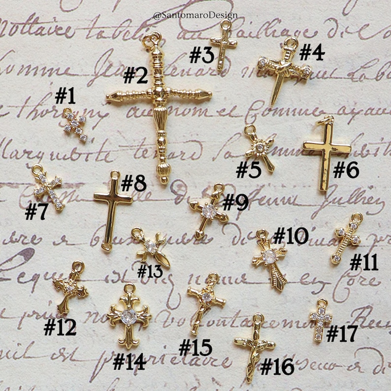 May include: A collection of gold-colored cross charms, each with a unique design. Some crosses feature sparkling embellishments, while others have a simple, elegant look. The charms are numbered for easy selection, perfect for jewelry making or religious crafts.