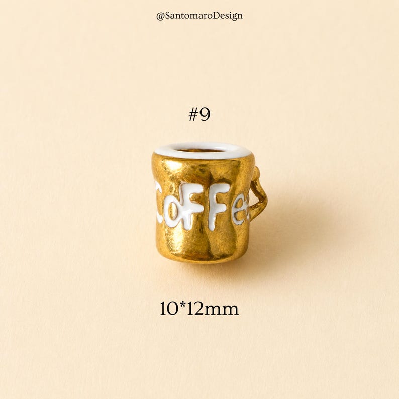 May include: A small, gold-colored ceramic coffee mug with the word "Coffee" in white lettering. The mug has a white interior and a small handle. The dimensions are 10mm x 12mm. The number "#9" is above the mug.