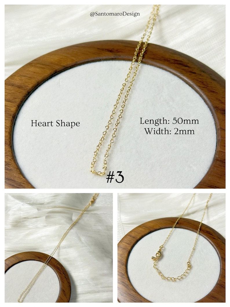 Op de afbeelding: Een delicate goudkleurige ketting met een hartvormige hanger. De ketting wordt gepresenteerd op een wit oppervlak in een houten frame. Tekst op de afbeelding luidt "Heart Shape", "Length: 50mm", "Width: 2mm" en "#3".