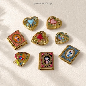 May include: A collection of gold-toned lockets and miniature books. The heart-shaped lockets feature colorful enamel designs, including floral patterns and a blue heart. The miniature books have cat illustrations.
