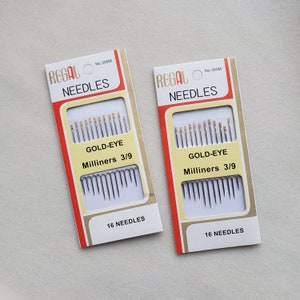 May include: Two packages of Regal Gold-Eye Milliners needles, size 3/9. Each package contains 16 needles and is labeled "No. 300M".