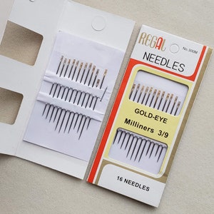 May include: A package of 16 gold-eye milliners needles, size 3/9, in a white and red cardboard box. The box says "Regal Needles No. 300M Gold-Eye Milliners 3/9 16 Needles".