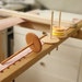 Wooden thread spool holder is attached to the embroidery frame. accessories for hand embroidery 