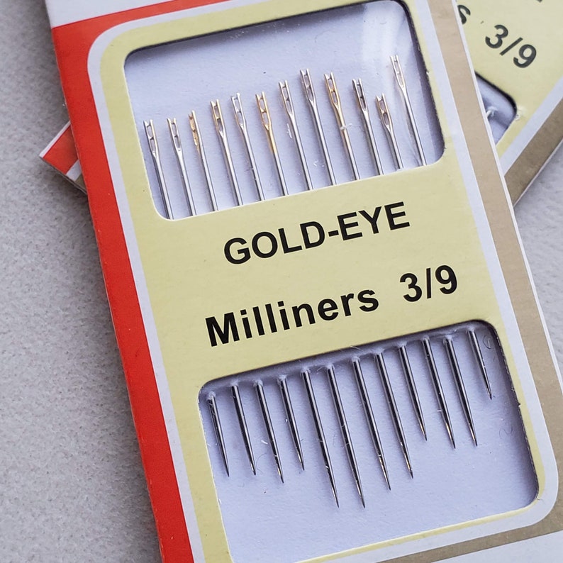 May include: A package of 12 gold-eye milliners needles, size 3/9. The needles are packaged in a clear plastic case with a white label that says "GOLD-EYE Milliners 3/9".