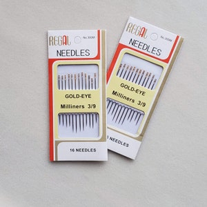 May include: Two packages of Regal Gold-Eye Milliners needles, size 3/9. Each package contains 16 needles and is labeled "No. 300M".