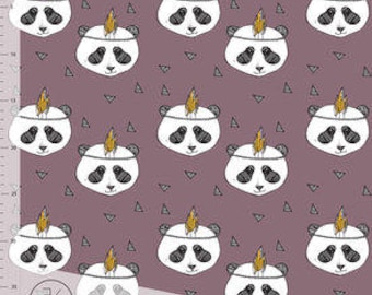May include: A repeating pattern of panda faces with a gold headdress on a mauve background. The pandas are white with black markings around their eyes and ears. Small black triangles are scattered throughout the design. A ruler is visible on the left side.