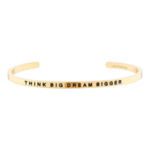 May include: Gold-toned bangle bracelet with the inscription "Think Big Dream Bigger".