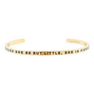 May include: Gold-toned bangle bracelet with the inscription "Though she be but little, she is fierce".