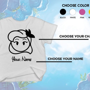 May include: White t-shirt featuring a black cartoon illustration of a character's face with a bow. The text "Your Name" is below the illustration. The image includes options to choose the t-shirt color and character.