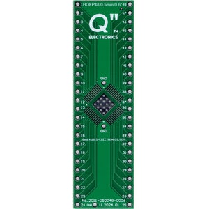 May include: A green circuit board with 48 pins, labeled "1HQFP48 0.5mm 0.6"48". The board has a white chip in the center and the text "Q™ ELECTRONICS" printed on the board.