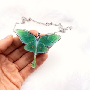Close-up of the stunning green hues of the Green Lunar Moth Pendant - A calming and serene addition to your jewelry collection
