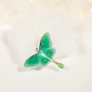 Close-up of the intricate details of the Green Lunar Moth Pendant - A unique addition to your jewelry collection