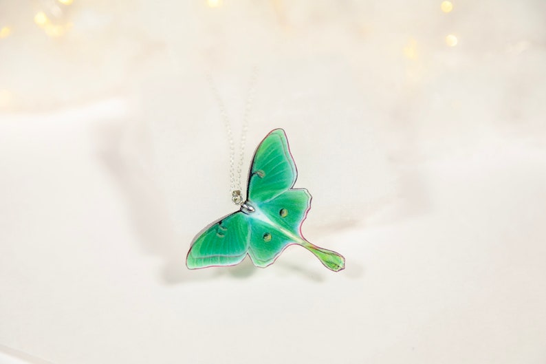 Close-up of the intricate details of the Green Lunar Moth Pendant - A unique addition to your jewelry collection
